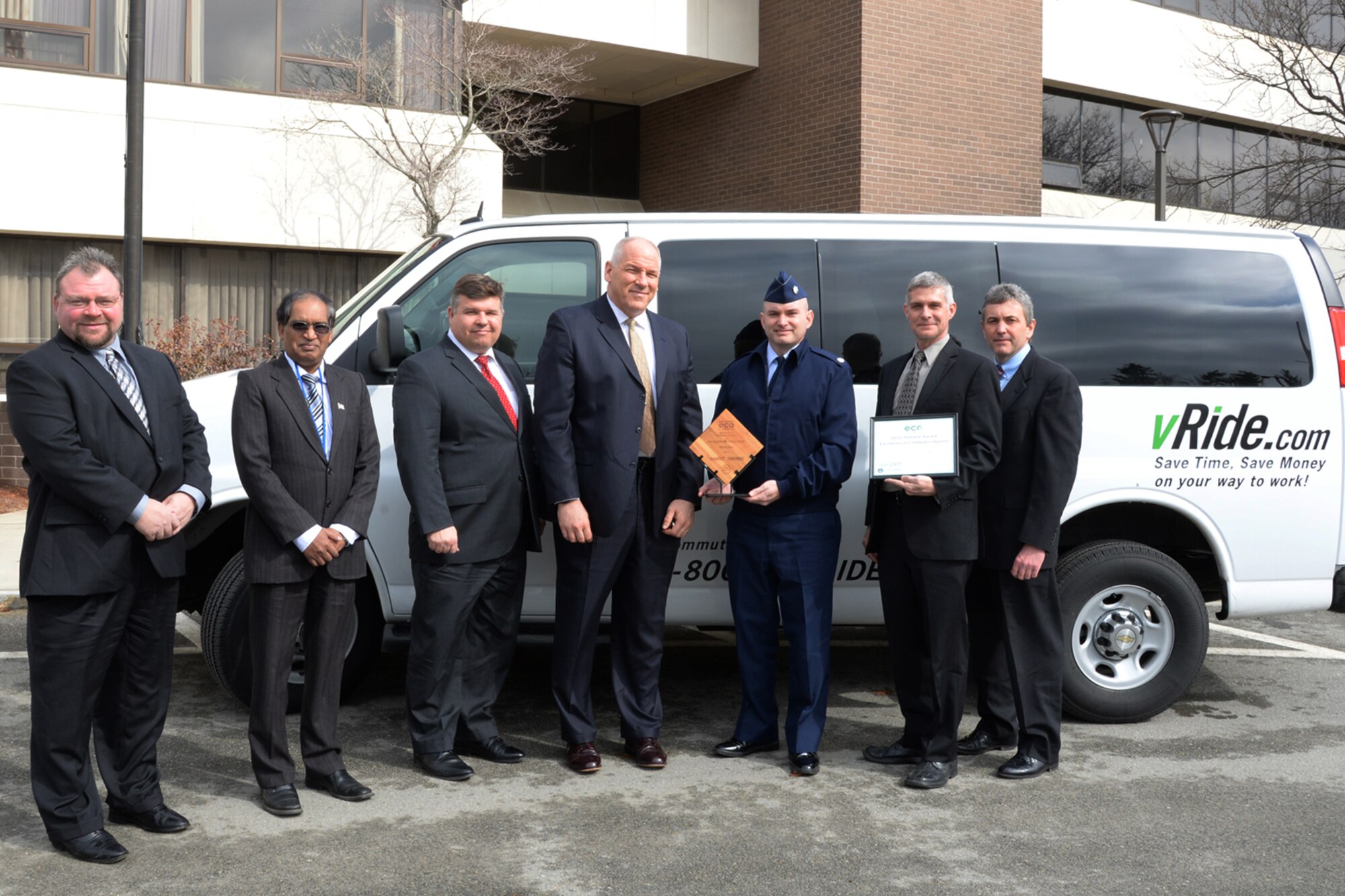 From left to right, Chris Simpson, Mazibur Khan, Tom Fredericks, Tom Schluckebier, Lt. Col. David Dunklee, Scott Sheehan and Robert Durant stand beside a commuter van with awards in hand after returning from the 5th annual Excellence in Commuter Options Awards Ceremony as a Massachusetts Department of Transportation “Rising Star Spotlight Award” recipient March 26 at Fenway Park in Boston. The award recognizes Massachusetts employers and their efforts to reduce congestion and greenhouse gas emissions by encouraging employees to utilize green transportation options. (U.S. Air Force photo by Linda LaBonte Britt)
