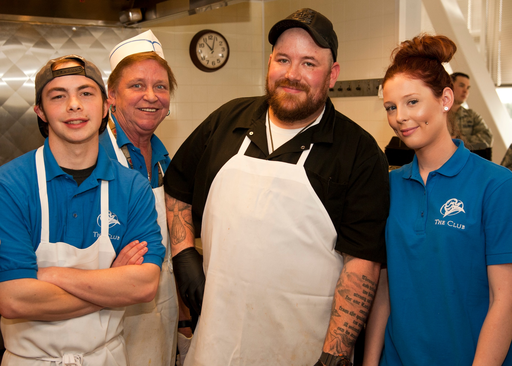 PETERSON AIR FORCE BASE, Colo. – (From left to right) Stefan Biando, Kim Lambrite, Chef Kirk Dunning and Bree Clark, Club One staff, pose for a photo during the grand opening of the newly remodeled and renamed Air Force Space Command snack bar, March 18. The event included a pizza buffet provided by the Colorado Pizza Company along with a raffle for prizes to the golf course, bowling center and other on-base facilities. Club One is open from 7 a.m.–1:30 p.m. Monday-Friday, and among its selection offers eggs, bacon, pancakes and breakfast burritos in the morning, while serving a variety of hot and cold sandwiches, burgers, soups, a daily salad bar and many other options. (U.S. Air Force photo by Staff Sgt. J. Aaron Breeden)