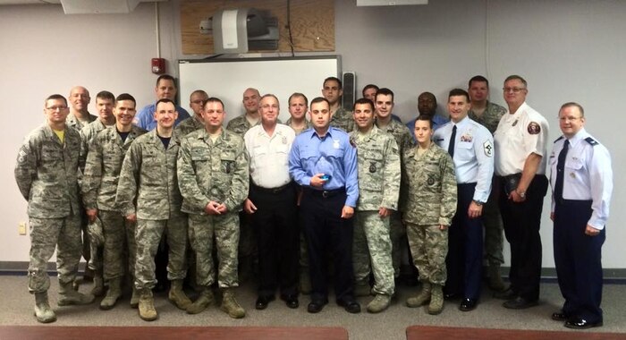 Leaders of Joint Base Charleston pause for a group photo with the 628th Civil Engineer Squadron fire department after an awards ceremony at Fire Station #1, JB Charleston, S.C., Mar. 27, 2015. The fire department won three out of a total of four AMC level annual awards. (U.S. Air Force photo/Tech. Sgt. Renae Pittman)
