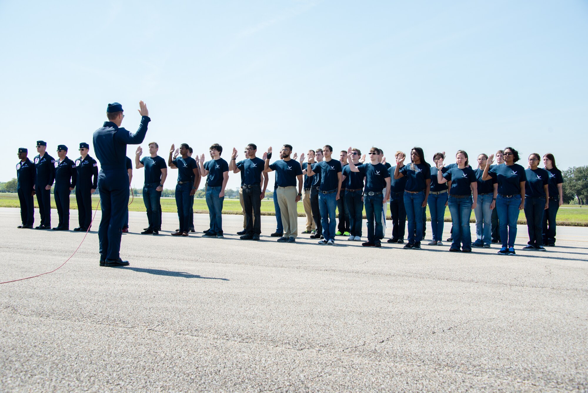 Maj. Tyler Ellison, U.S. Air Force Thunderbirds operations officer #7, delivers the oath of enlistment during an enlistment ceremony March 28, 2015, at Keesler Air Force Base, Miss. Twenty-nine individuals enlisted.  The event included the U.S. Air Force Thunderbirds and Army Golden Knights along with many other performers, static displays and vendors.  Approximately 155,000 people were in attendance for the two-day show. (U.S. Air Force photo by Marie Floyd)