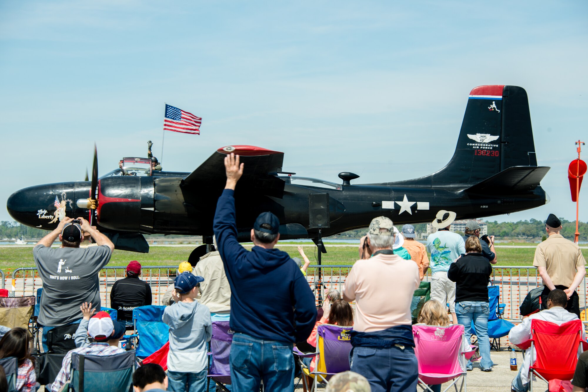 Crowds wave as the Lady Liberty aircraft passes by during Keesler’s 2015 Air Show/Open House March 28, 2015, at Keesler Air Force Base, Miss.  The event included the U.S. Air Force Thunderbirds and Army Golden Knights along with many other performers, static displays and vendors.  Approximately 155,000 people were in attendance for the two-day show. (U.S. Air Force photo by Marie Floyd)