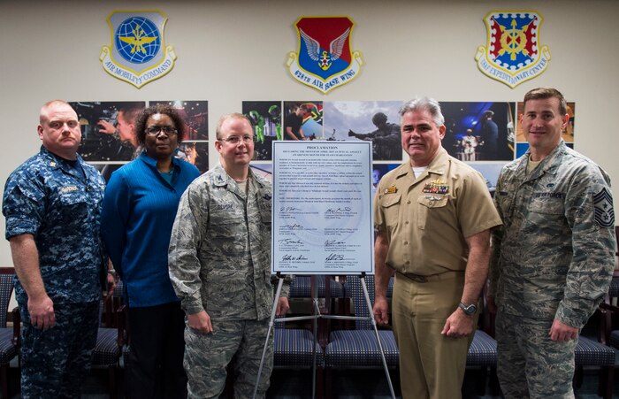 From left to right: Command Master Chief Petty Officer Joseph Gardner, Naval Support Activity command master chief; Florine King, JB Charleston - Air Base SARC; Col. Jeffrey DeVore, Joint Base Charleston commander; Capt. Timothy Sparks, JB Charleston deputy commander and Command Chief Mark Bronson, 628th Air Base Wing command chief sign a proclamation declaring the month of April 2015 as sexual assault awareness month for Team Charleston. The signing ceremony took place in the 628th ABW conference room March 31. The theme for sexual assault awareness month this year is, “Eliminate Sexual Assault: Know your part. Do your part.” The purpose of sexual assault awareness month is to raise awareness about sexual assault prevention and support sexual assault survivors.  (U.S. Air Force photo/Airman 1st Class Clayton Cupit)