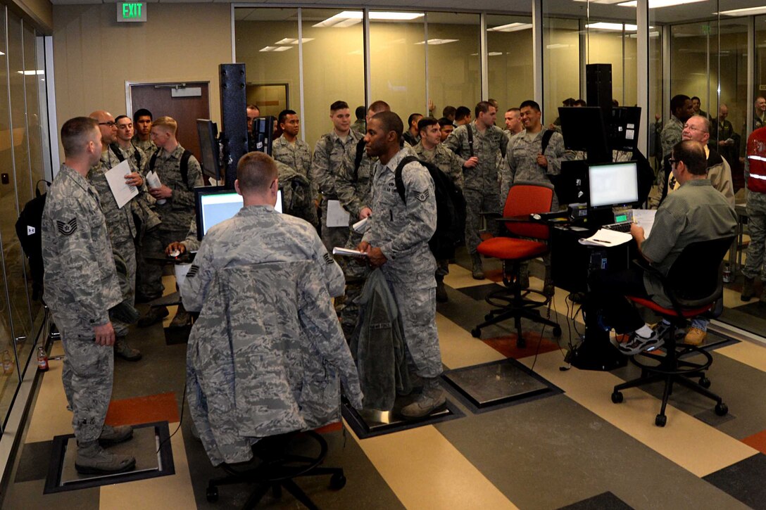 Airmen process through a mobility line prior to leaving for Red Flag 15-2 at the Deployment Center at Ellsworth Air Force Base, S.D., Feb. 26, 2015. Red Flag exercises have provided training for more than 440,000 military personnel, including more than 145,000 aircrew members flying more than 385,000 sorties, logging more than 660,000 hours of flying time. (U.S. Air Force photo by Airman 1st Class Rebecca Imwalle/Released)