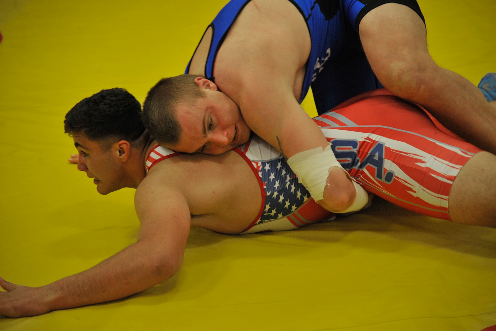 FORT CARSON, Colo. – Airman 1st Class Eric Lapotsky, based out of Barksdale AFB, Louisiana, and representing the U.S. Air Force in the 97kg weight class, works to roll his opponent during the 2015 Armed Forces Wrestling Championship at Fort Carson, March 27. This two-day event pitted members from each branch of the Department of Defense against one another in Greco Roman and freestyle wrestling matches. (U.S. Air Force photo by Robb Lingley) 