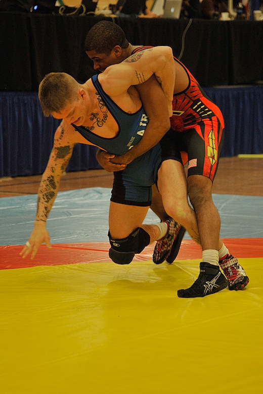 FORT CARSON, Colo. – Senior Airman Nathan Higgins, based out of RAF Lakenheath, United Kingdom, and representing the U.S. Air Force in the 66kg weight class, works to escape his opponent’s grasp during the 2015 Armed Forces Wrestling Championship at Fort Carson, March 27. This two-day event pitted members from each branch of the Department of Defense against one another in Greco Roman and freestyle wrestling matches. (U.S. Air Force photo by Robb Lingley)