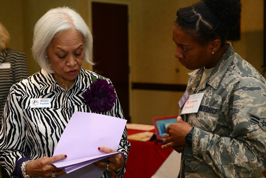 U.S. Air Force Airman 1st Class Treyonna Johnson, right, 23d Force Support Squadron fitness apprentice, asks Ululani Packett, Military Child Education Coalition facilitator, about registration advice for the Living in the New Normal Institute March 25, 2015, at a hotel in Valdosta, Ga. The participants were given the opportunity to receive a credit towards their college education upon completion of training. (U.S. Air Force photo by Airman 1st Class Kathleen D. Bryant)