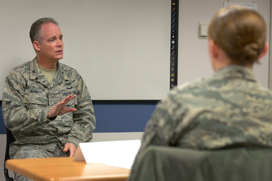 Col. Michael A. Vogel, 66th Air Base Group commander, talks to Airmen during a class for first term Airman at the base Education Center, Mar. 30. The First Term Airman Center course is to assist Airmen arriving at their first duty station in the Air Force. Airmen learned about managing personal finances, resiliency, suicide prevention and substance abuse education and prevention. (U.S. Air Force photo by Jerry Saslav)
