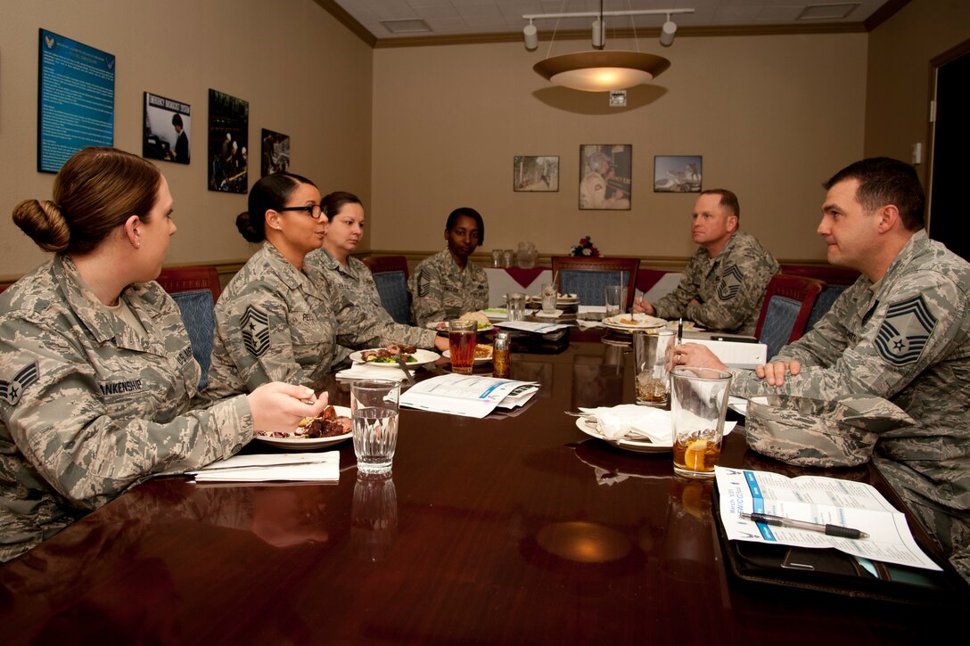 PETERSON AIR FORCE BASE, Colo. – Senior Airman Meagan Blankenship ( far left), 21st Medical Group Bioenvironmental Engineering technician and Chief Master Sgt. Idalia Peele (second from left), 21st Space Wing command chief, discuss current matters of the wing during a working lunch with chief master sergeants from other 21st Space Wing units at The Club, March 18. Blankenship spent the day with Peele as part of a newly implemented shadow program, which affords Peele the opportunity to better know the Airmen of the 21st Space Wing, and to allow junior Airmen a chance to see the “big picture” and better understand how and why base-impacting decisions are made. (U.S. Air Force photo by Staff Sgt. J. Aaron Breeden)