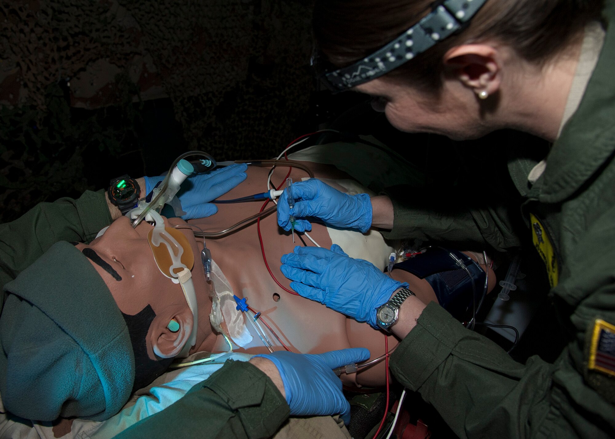 Capt. Joanna Cooley, a nurse with the 96th Medical Group’s Critical Care Flight, inserts a large bore catheter into the chest of a simulated patient, Feb. 24 at Eglin Air Force Base, Fla.  The large bore catheter is used to relieve a collapsed lung on a simulated patient.  The Critical Care Air Transport Team performs sustainment training in a simulated aircraft environment to hone their deployment and emergency response skills under stressful conditions. CCATT crews manage multiple critically ill and injured service members on flights around the world to ensure their survival.  (U.S. Air Force photo/Ilka Cole)