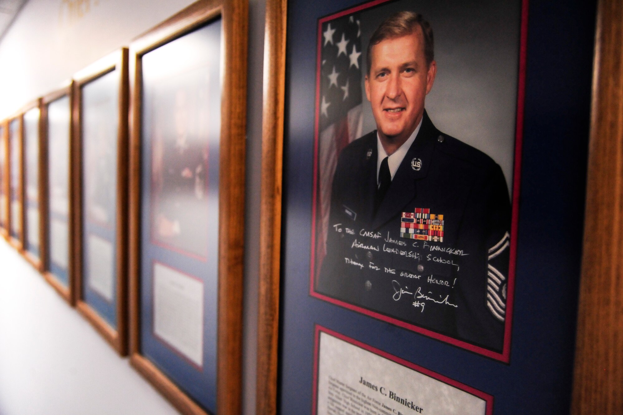 A portrait of retired Chief Master Sgt. of the Air Force James C. Binnicker, the ninth CMSAF, hangs on the wall in the James C. Binnicker Airman Leadership School, March 27, 2015, at Seymour Johnson Air Force Base, North Carolina. The ALS held a remembrance ceremony in Binnicker’s honor following his recent passing on March 21 at the age of 76. (U.S. Air Force photo/Senior Airman Brittain Crolley)