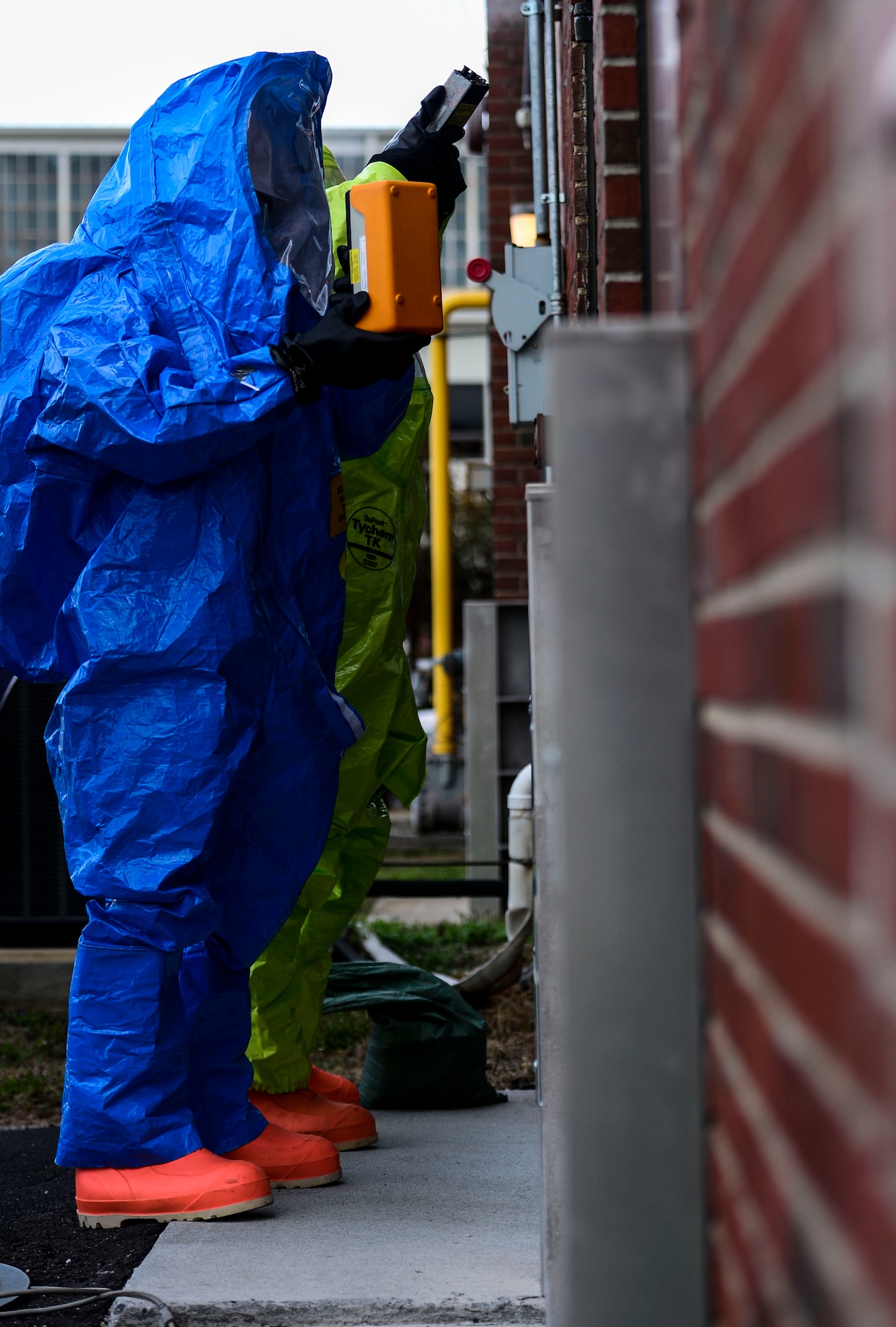 A U.S. Air Force Airman tests for simulated hazardous material during a chemical, biological, radiological, nuclear and high-yield explosive threat exercise at Langley Air Force Base, Va., March 26, 2015. The exercise tested emergency personnel’s ability to respond and contain a CBRNE threat on the installation.  (U.S. Air Force photo by Senior Airman Kayla Newman/Released)