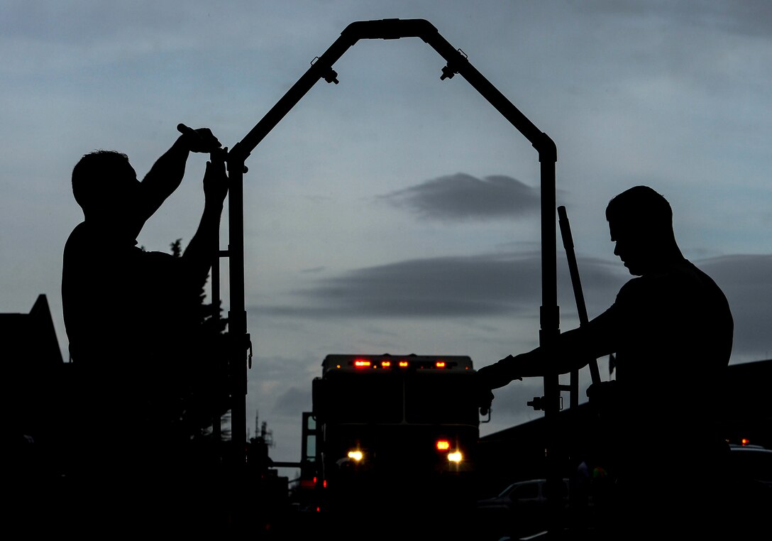 U.S. Air Force firefighters construct a decontamination station at Langley Air Force Base, Va., March 26, 2015. Emergency responders participated in a chemical, biological, radiological, nuclear and high-yield explosive threat exercise and were tested on their ability to plan, organize, train and respond to threats. (U.S. Air Force photo by Senior Airman Kayla Newman/Released)