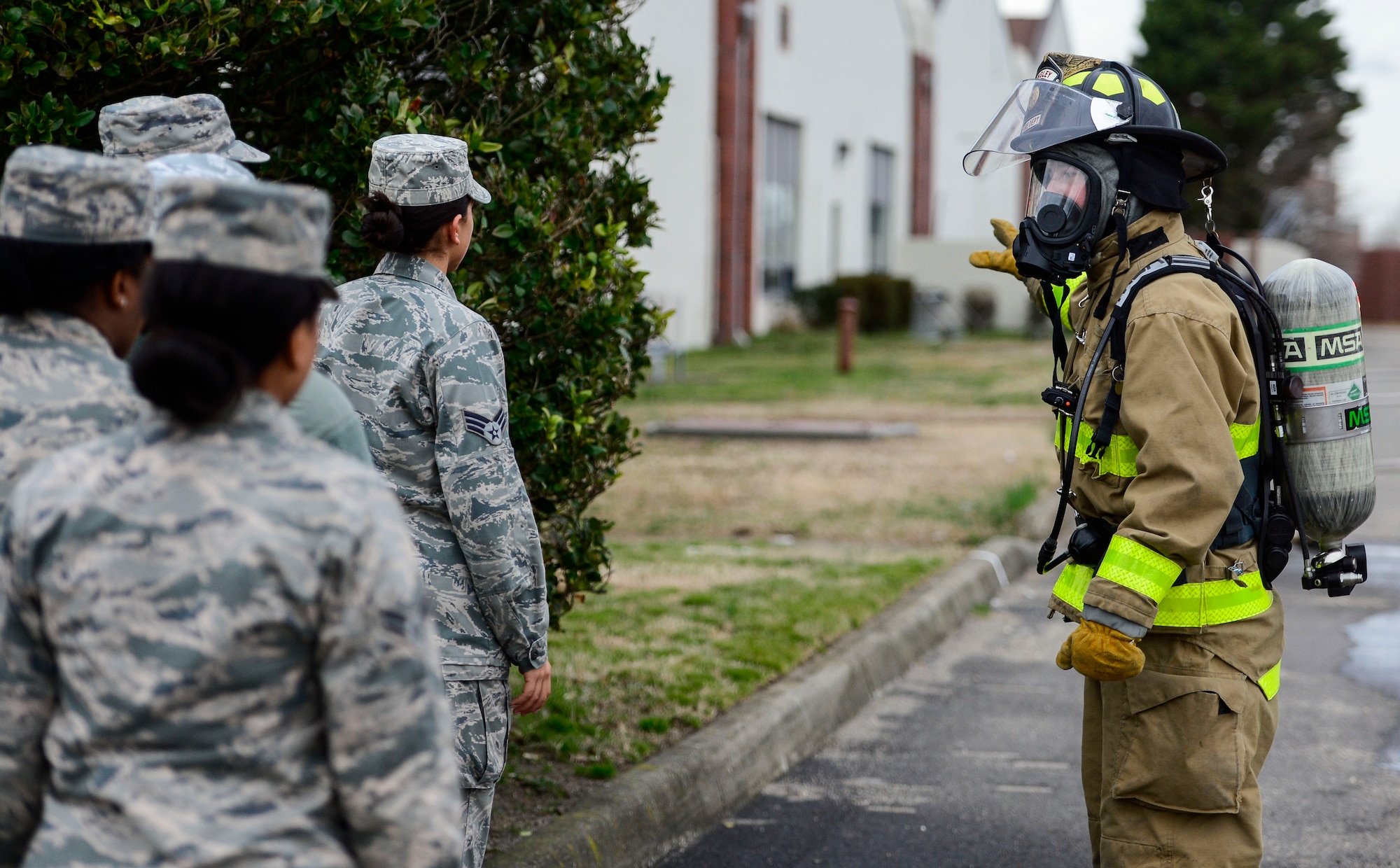 U.S. Air Force Staff Sgt. Geoffrey Range, 633rd Civil Engineer Squadron firefighter, instructs a group of evacuees during a simulated chemical, biological, radiological, nuclear and high-yield explosive threat during an exercise at Langley Air Force Base, Va., March 26, 2015. The exercise tested Joint Base Langley-Eustis personnel’s ability to respond to preplanned, indiscriminate use of CBRNE weapons aimed the installation. (U.S. Air Force photo by Senior Airman Kayla Newman/Released)