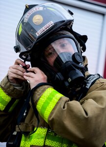 U.S. Air Force Staff Sgt. Geoffrey Range, 633rd Civil Engineer Squadron firefighter, dons a helmet during a chemical, biological, radiological, nuclear and high-yield explosives exercise at Langley Air Force Base, Va., March 26, 2015. The exercise tested base emergency response teams ability to react to CBRNE threats. (U.S. Air Force photo by Senior Airman Kayla Newman/Released)(