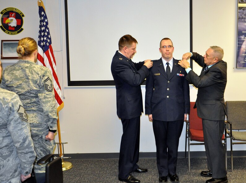 WRIGHT-PATTERSON AIR FORCE BASE, Ohio – Col. Jeffrey S. Beery, 445th Aeromedical Staging Squadron commander and Tom Charles, father of 2nd Lt. Jonathan D. Charles pin on second lieutenant bars during Jonathan's promotion ceremony March 21, 2015.. Tech. Sgt. Jonathan D. Charles was commissioned as a second lieutenant in the Medical Service Corps. Charles will remain a member of the squadron where his hard work and dedication is truly appreciated. (U.S. Air Force photo/Maj. Demetrius Smith)