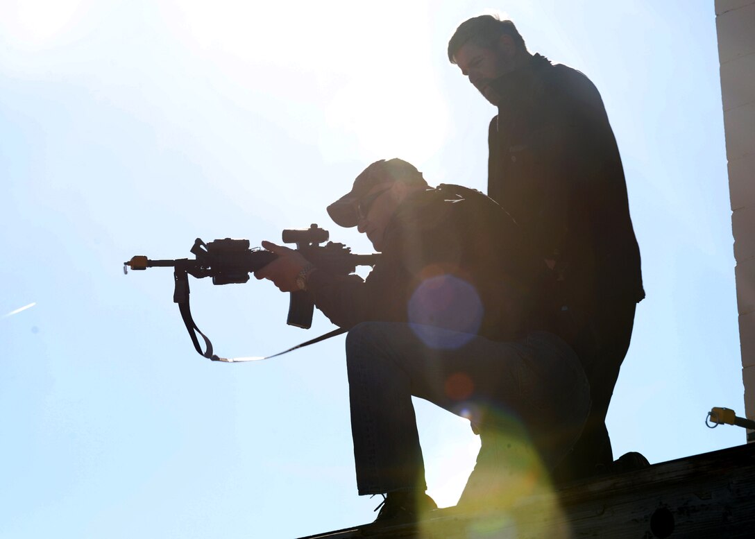 John Kost, 28th Security Forces Squadron flight chief, simulates a firing scenario with an M4 rifle at Ellsworth Air Force Base, S.D., March 10, 2015. 28th SFS members engage in more than 200 hours of training annually, from combative skills to taser and law enforcement training. (U.S. Air Force photo by Airman 1st Class Rebecca Imwalle/Released)