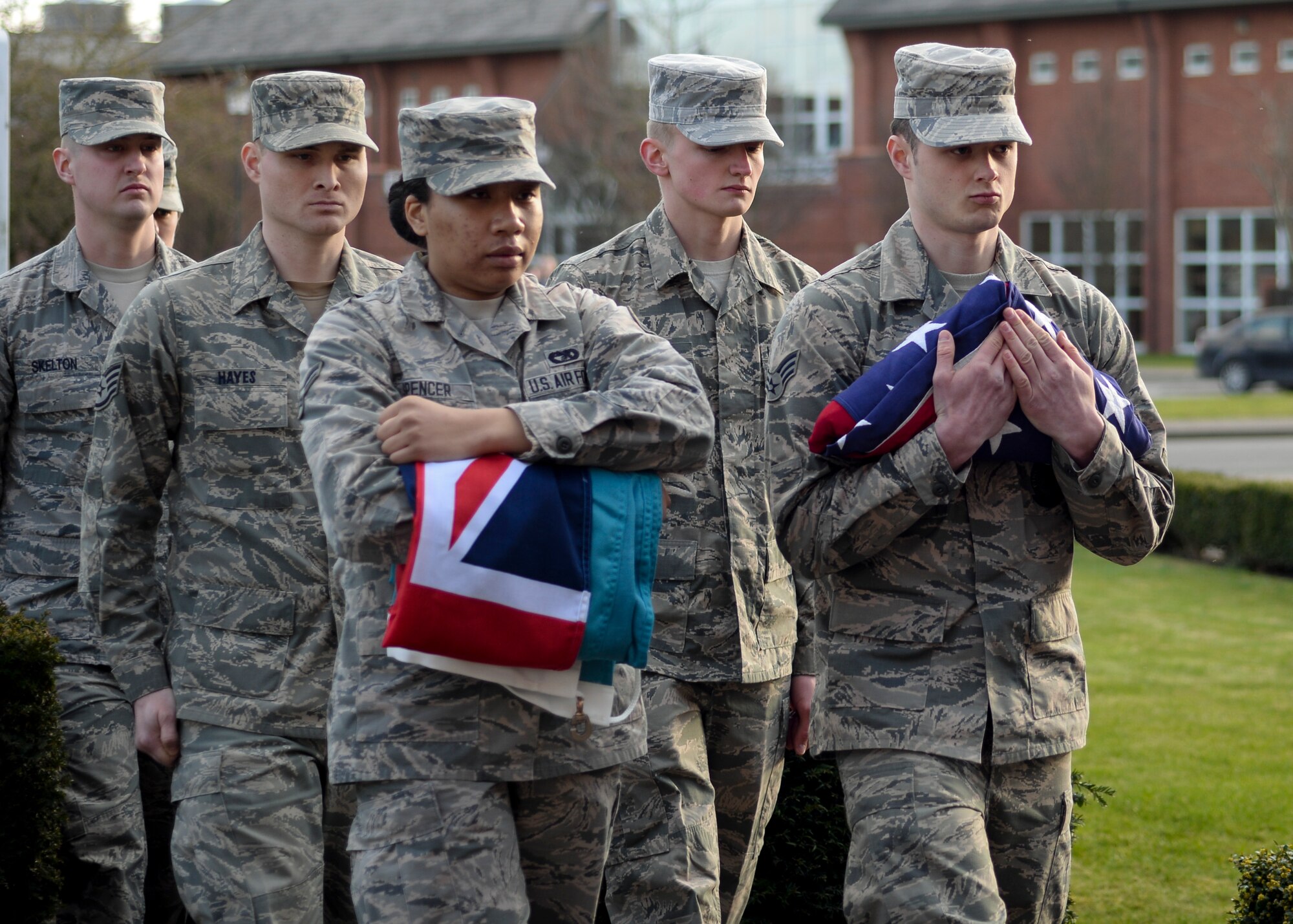 Members of the Team Mildenhall Honor Guard carry the U.S. and RAF flags during a retreat ceremony March 27, 2015, on RAF Mildenhall, England. Retreat is a long-standing tradition honoring the flag and signaling the end of the duty day. (U.S. Air Force photo by Senior Airman Victoria H. Taylor/Released)