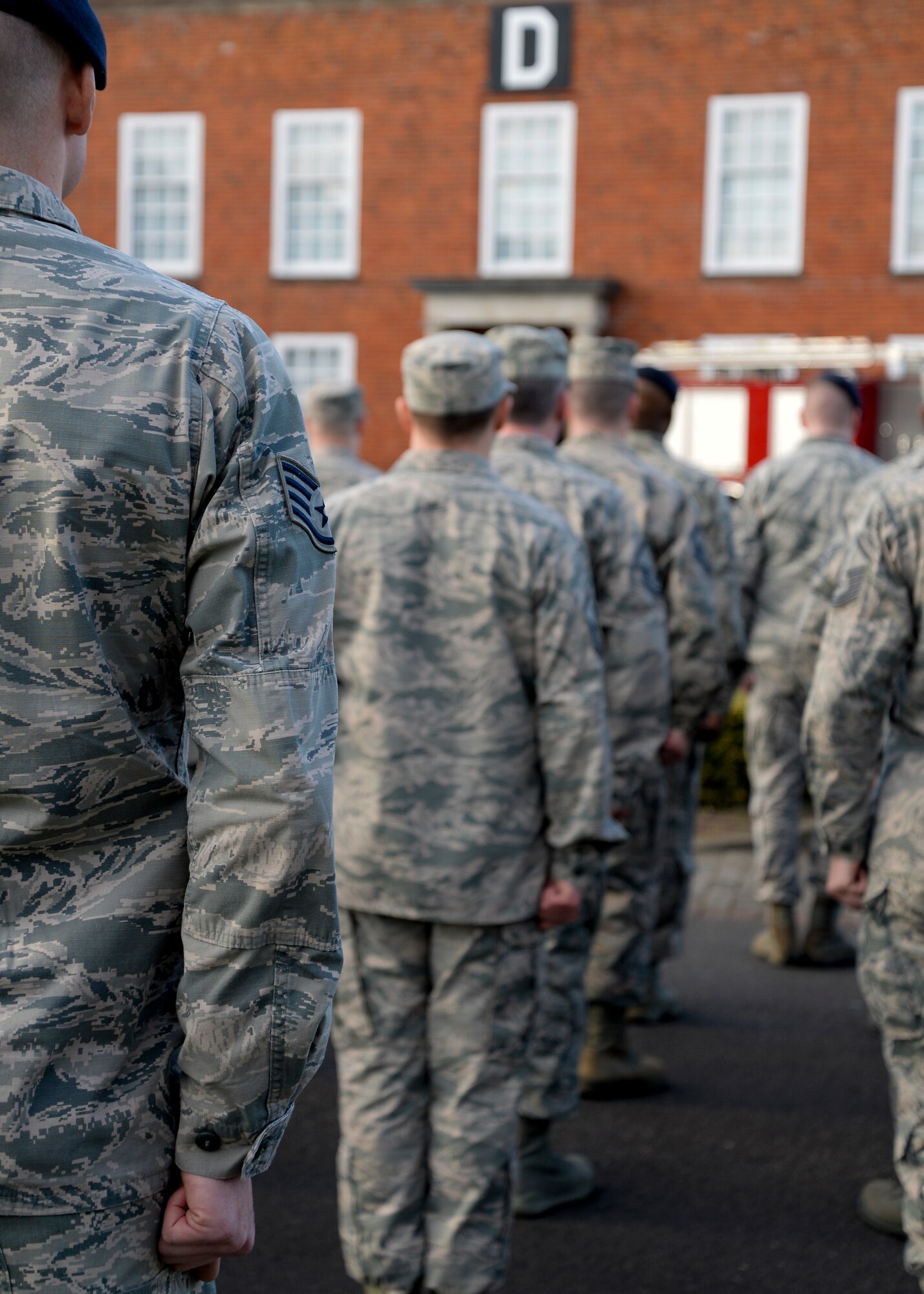 Team Mildenhall Airmen stand in formation during a retreat ceremony March 27, 2015, on RAF Mildenhall, England. Retreat is a long-standing tradition honoring the flag and signaling the end of the duty day. (U.S. Air Force photo by Senior Airman Victoria H. Taylor/Released)