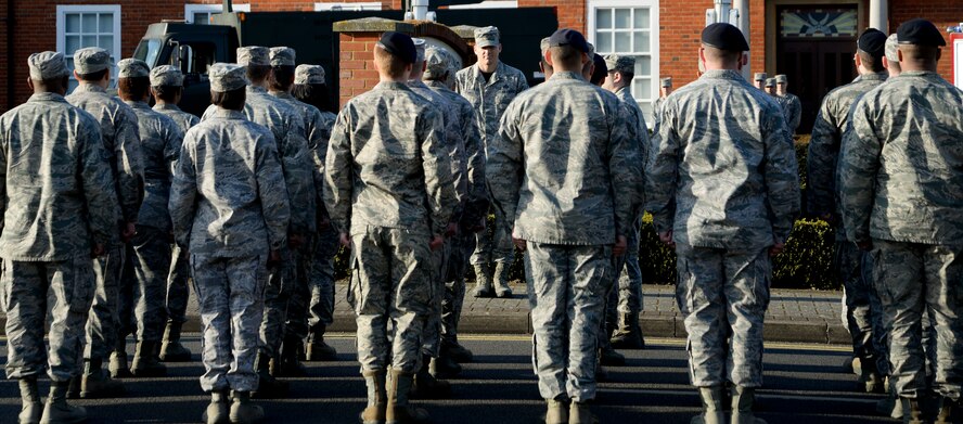 Members of Team Mildenhall stand in formation waiting for a retreat ceremony to begin March 27, 2015, at RAF Mildenhall, England. The ceremony was held in honor of Chief Master Sgt. Tracy Jones, 100th Air Refueling Wing command chief, as he prepares to retire from active duty. (U.S. Air Force photo by Senior Airman Victoria H. Taylor/Released)