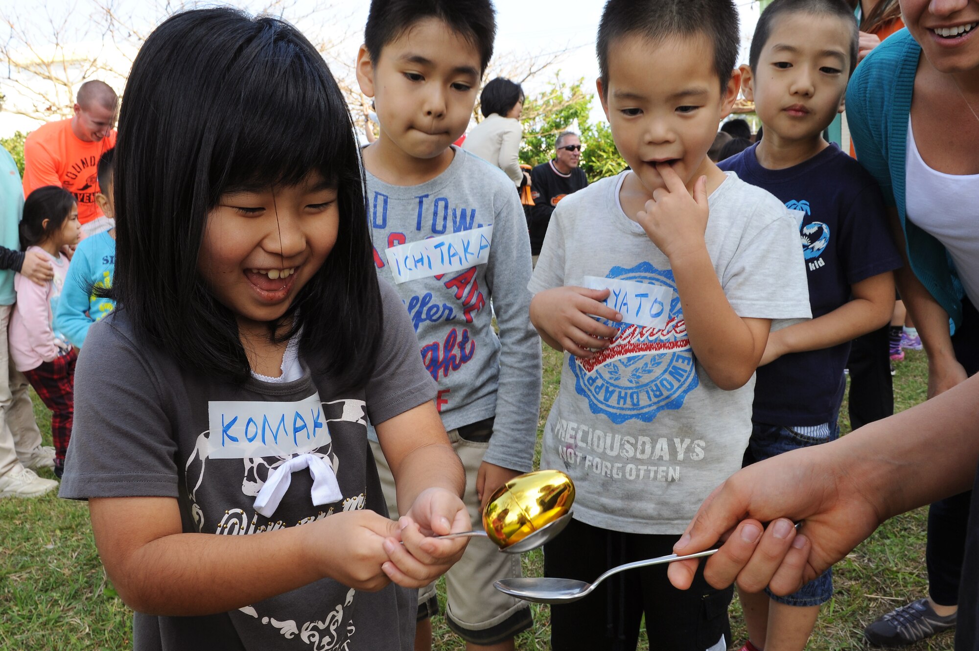 A child from the Midori School-Age Program transfers a plastic egg from one spoon to another during a relay race in Okinawa City, Japan, March 26, 2015. The relay race was one of several games and activities set up for local children by members of the Wisconsin Air National Guard's 115th Fighter Wing. (U.S. Air Force photo by Airman 1st Class Zade C. Vadnais)