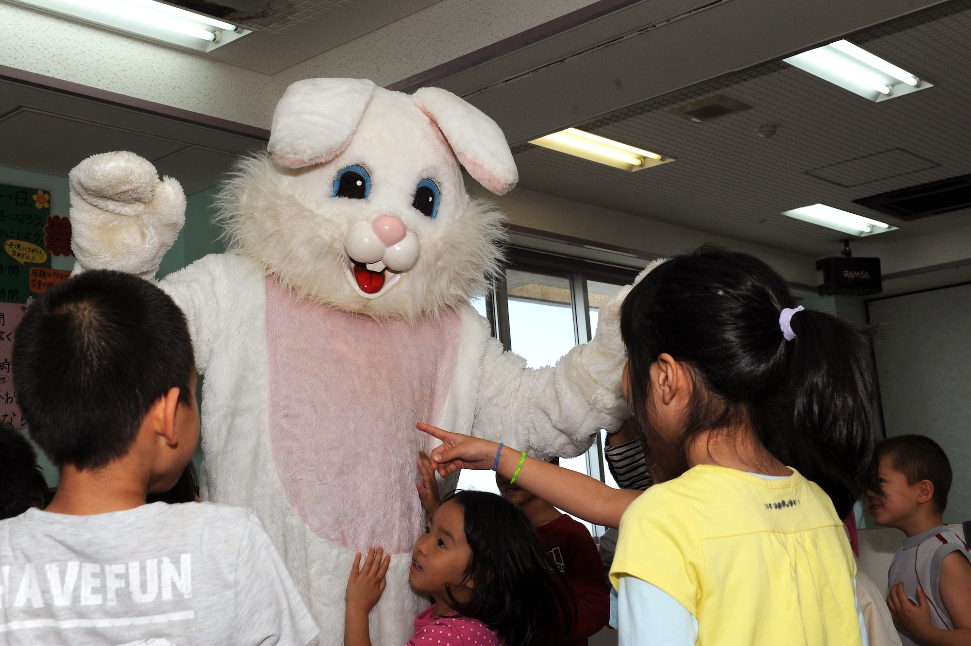 The Easter Bunny surprises children from the Midori School-Age Program in Okinawa City, Japan, March 26, 2015. Members from the Wisconsin Air National Guard 115th Fighter Wing organized a visit to the center in order to interact with the local community during their time on the island. (U.S. Air Force photo by Airman 1st Class Zade C. Vadnais)