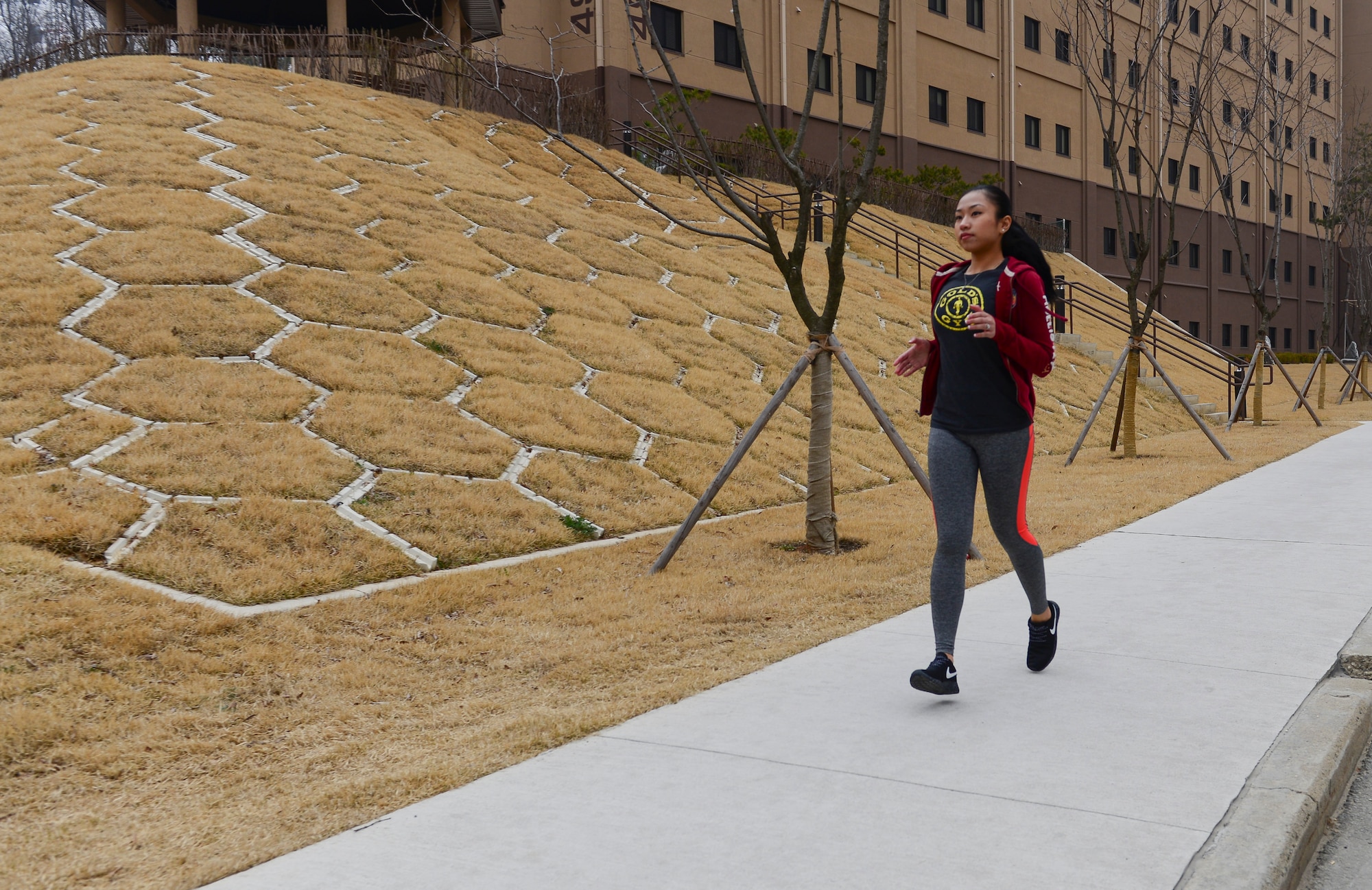 Staff Sgt. Alora Danah Aguelo, 51st Force Support Squadron career development technician, runs on a sidewalk March 29, 2015 at Osan Air Base, Republic of Korea. Aguelo is this week's Team Osan Spotlight winner. (U.S. Air Force photo by Senior Airman David Owsianka)