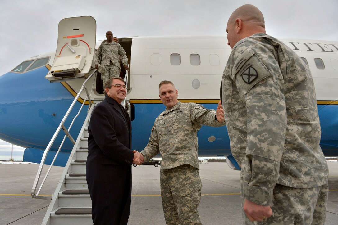 Army Maj. Gen. Jeffrey Bannister, center, commander of the 10th Mountain Division, and Command Sgt. Maj. Ray Lewis, right, welcome Defense Secretary Ash Carter to Fort Drum, N.Y., March 30, 2015. Carter spoke with soldiers and military family members at Fort Drum about the force of the future, and how the military can retain its best people and their battle-tested skills.