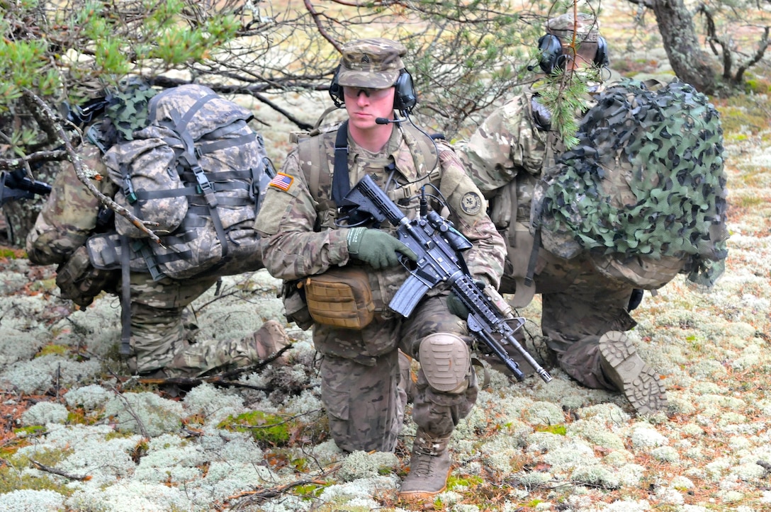 U.S. soldiers participate in a patrol after conducting a water infiltration exercise with Latvian and Canadian recon teams near the Adazi military base, Latvia, March 30, 2015.