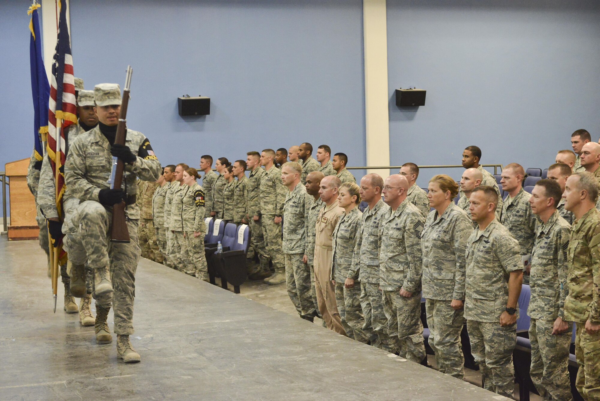 Al Udeid Honor Guardsman presents the colors during a Community College of the Air Force recognition ceremony April 28, 2015, at the Blatchford-Preston Complex theater Al Udeid Air Base, Qatar. Honor Guard is a volunteer program here that allows service members of all branches to perform during base ceremonies and events. (U.S. Air Force photo/Staff Sgt. Alexandre Montes)