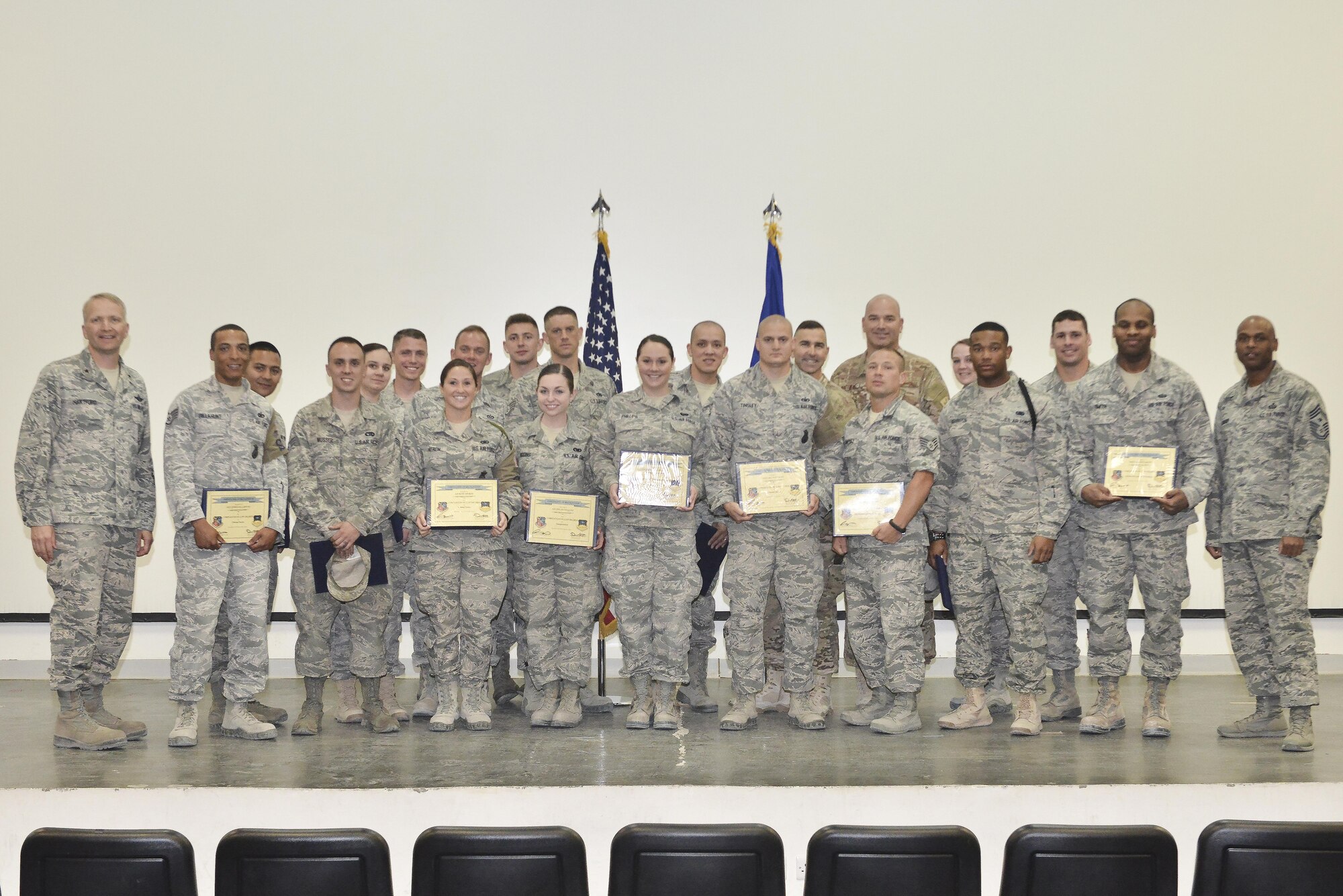 Airmen that received their Community College of the Air Force diplomas pose for a group photo with Brig. Gen. Darren E. Hartford, Commander 379th Air Expeditionary Wing, and Chief Master Sergeant Danny L. Crudup, Command Chief, 379th Air Expeditionary Wing, April 28, 2015, at the Blatchford-Preston Complex theater Al Udeid Air Base, Qatar. The Community College of the Air Force is a regionally-accredited school, and CCAF degrees are only offered to Air Force service members. Tuition assistance will cover many courses, through both on-campus and distance learning schools. The Base Education and Training Office are open from 8:00 a.m. until 8:00 p.m., Monday through Sunday and they can provide additional information on educational opportunities afforded to service members. The online Air Force Virtual Education Center, which can be accessed through the Air Force Portal, can provide additional information as well. (U.S. Air Force photo/Staff Sgt. Alexandre Montes)