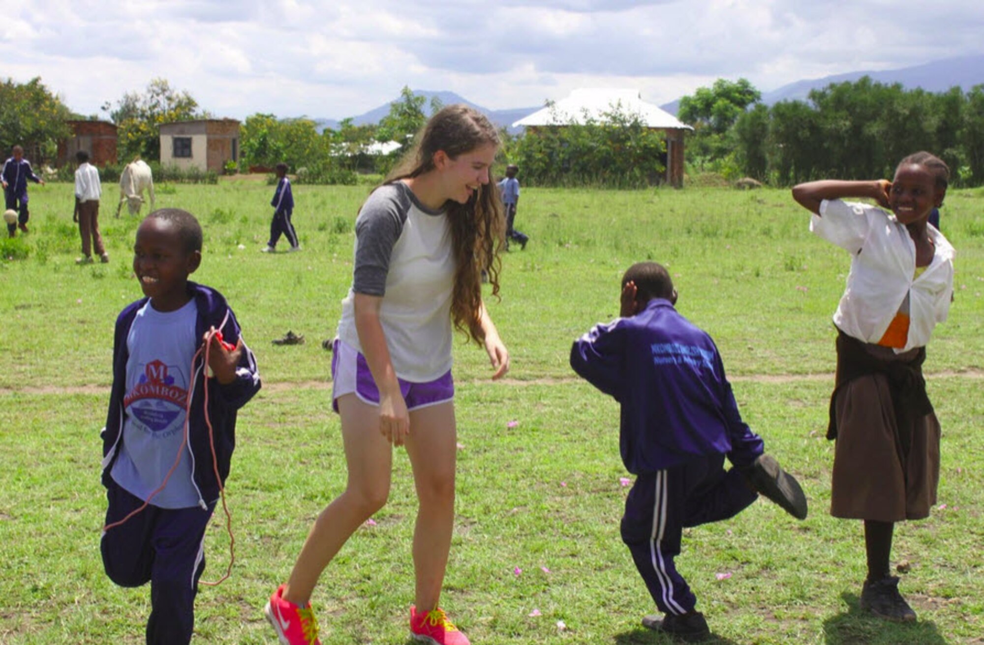 Sarah Hesterman dances with children from Tanzania during her visit to help construct schools for orphaned youth. (Courtesy Photo)