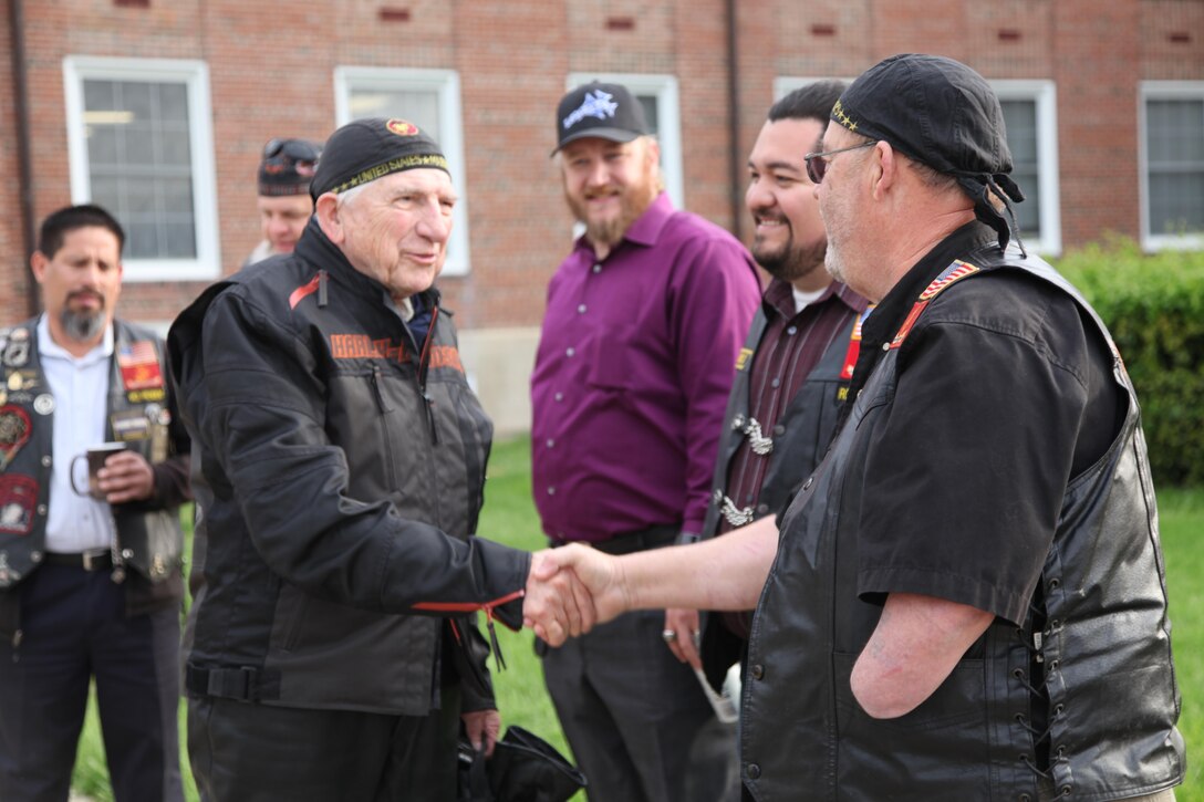 Dr. Bruce Heilman, left, 89,  a World War II Marine veteran from Richmond, greets Bill Watson, a member of the Band of Brothers Motorcycle Club during his visit to Marine Corps Base Quantico April 23. Heilman attended morning colors prior to embarking on a 6,000 mile cross-country motorcycle trip. Heilman, who is also the chancellor of the University of Richmond, enlisted in the Marine Corps at age 17 and served in the Pacific on Okinawa. He has dedicated his ride to honoring Gold Star Mothers. (Photo by David M. White/RELEASED)