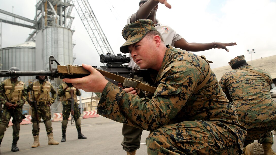 U.S. Marine Cpl. Anthony Bourne, a rifleman with Special-Purpose Marine Air-Ground Task Force Crisis Response-Africa, demonstrates room-clearing techniques to Angolan Marines in Luanda, Angola, March 4, 2015. U.S. Marines, British Royal Marines and Spanish Marines spent three days training with the Angolans in close-quarters combat, small boat operations and repair, and search and seizure techniques before departing for Cameroon during the maritime security exercise, Africa Partnership Station. (Official U.S. Marine Corps photo by Staff Sgt. Steve Cushman/Released)