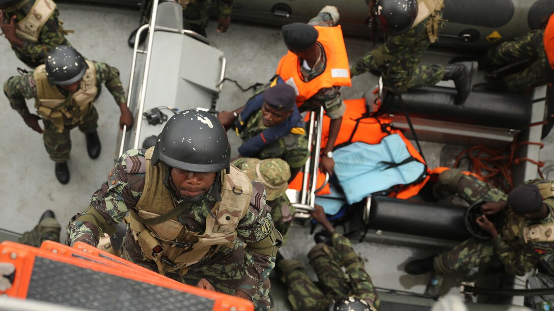 Angolan Marines, also known as Fuzileiros Navais da Marinha de Guerra Angolana, climb aboard the USNS Spearhead for an engagement in Luanda, Angola, March 4, 2015. U.S. Marines, British Royal Marines and Spanish Marines spent three days working with the Angolans in close-quarters combat, small boat operations and repair, and search and seizure techniques before departing for Cameroon during the maritime security exercise, Africa Partnership Station. (Official U.S. Marine Corps photo by Staff Sgt. Steve Cushman/Released)