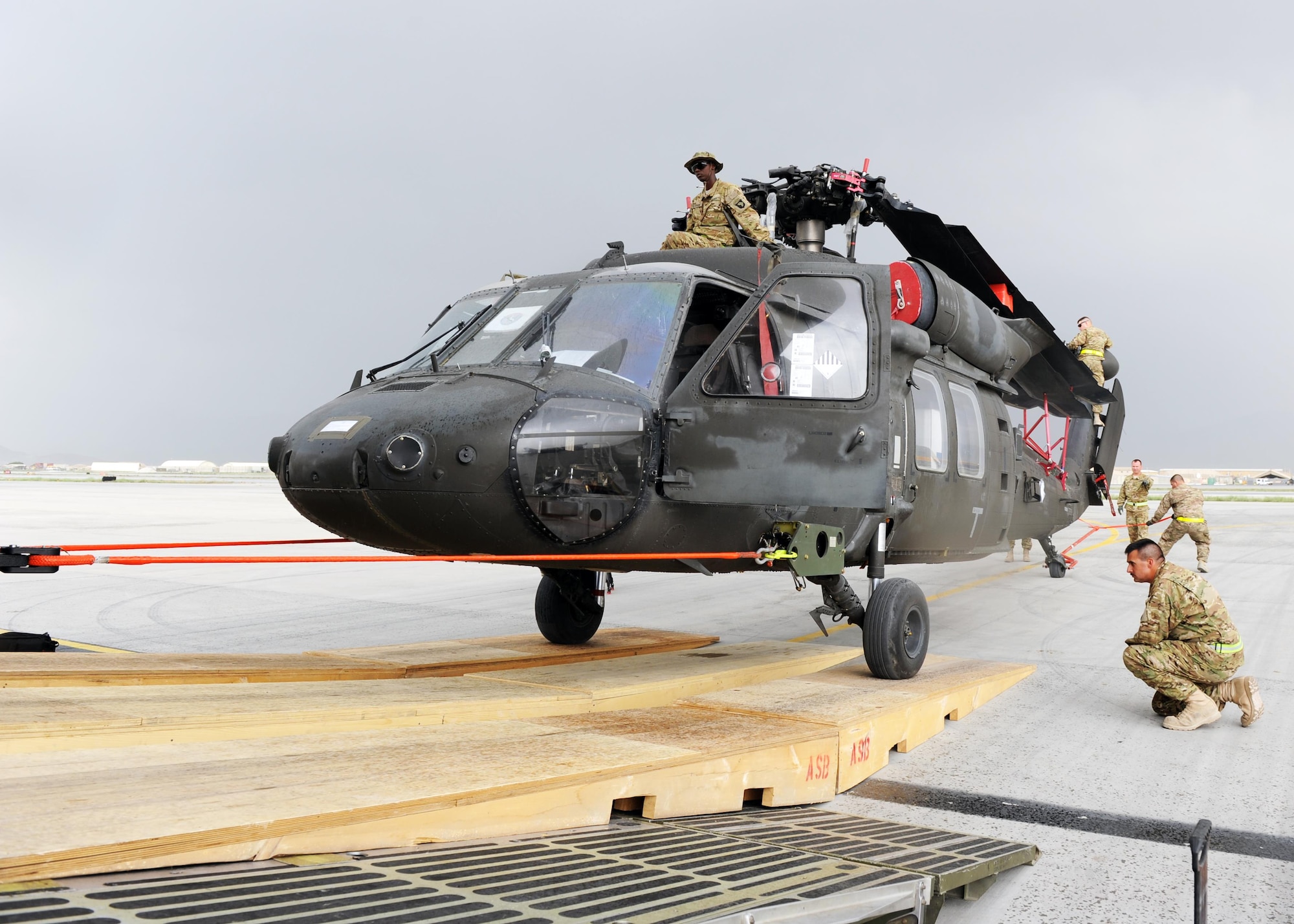 U.S. Soldiers assigned to the 96th Aviation Support Battalion, 101st Combat Aviation Brigade, spot and position an Army UH-60 Black Hawk helicopter during an upload onto a C-5 Super Galaxy aircraft April 26, 2015 at Bagram Airfield, Afghanistan. Throughout April, several helicopters were uploaded and transported to the United States to facilitate the swap out of the Army’s 82nd and 101st Combat Aviation Brigades. (U.S. Air Force photo by Staff Sgt. Whitney Amstutz/Released)