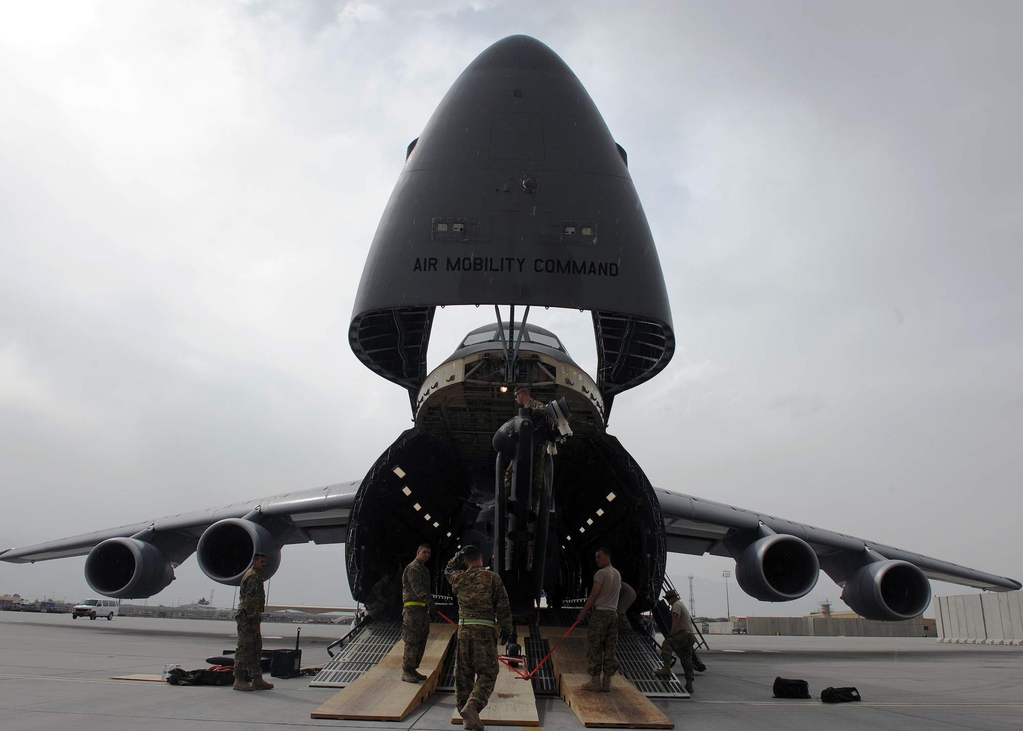 U.S. Soldiers assigned to the 96th Aviation Support Battalion, 101st Combat Aviation Brigade, spot and position an Army UH-60 Black Hawk helicopter during upload onto a C-5 Super Galaxy aircraft April 26, 2015 at Bagram Airfield, Afghanistan. Throughout April, several helicopters were uploaded and transported to the United States to facilitate the swap out of the Army’s 82nd and 101st Combat Aviation Brigades. (U.S. Air Force photo by Staff Sgt. Whitney Amstutz/Released)