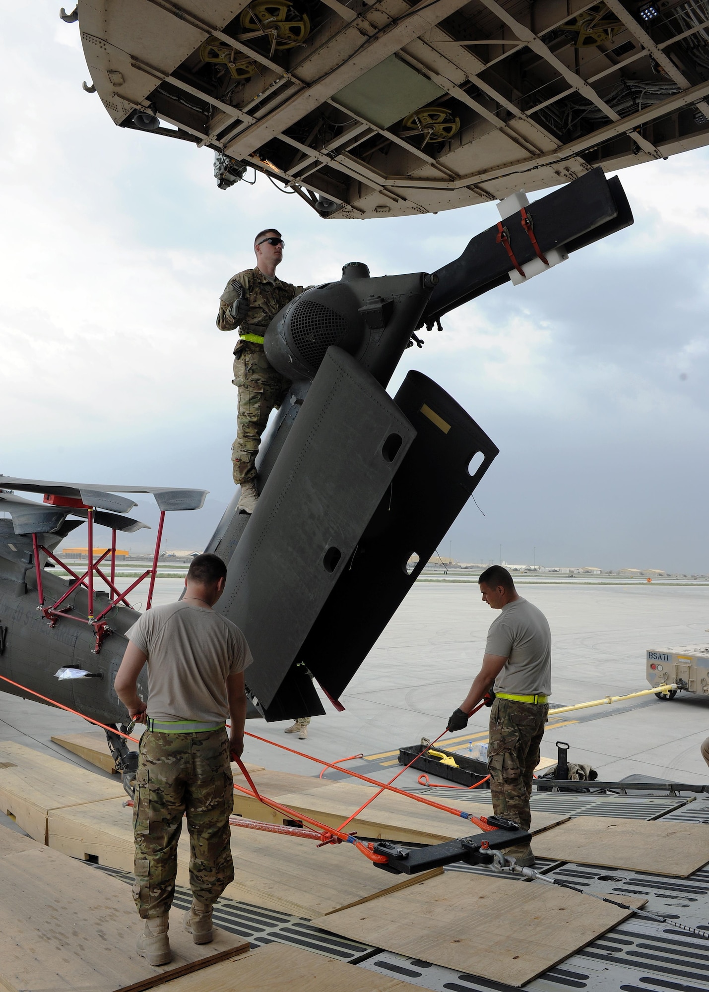 U.S. Soldiers assigned to the 96th Aviation Support Battalion, 101st Combat Aviation Brigade, spot and position an Army UH-60 Black Hawk helicopter while uploading onto a C-5 Super Galaxy aircraft April 26, 2015 at Bagram Airfield, Afghanistan. Throughout April, several helicopters were uploaded and transported to the United States to facilitate the swap out of the Army’s 82nd and 101st Combat Aviation Brigades. (U.S. Air Force photo by Staff Sgt. Whitney Amstutz/Released)