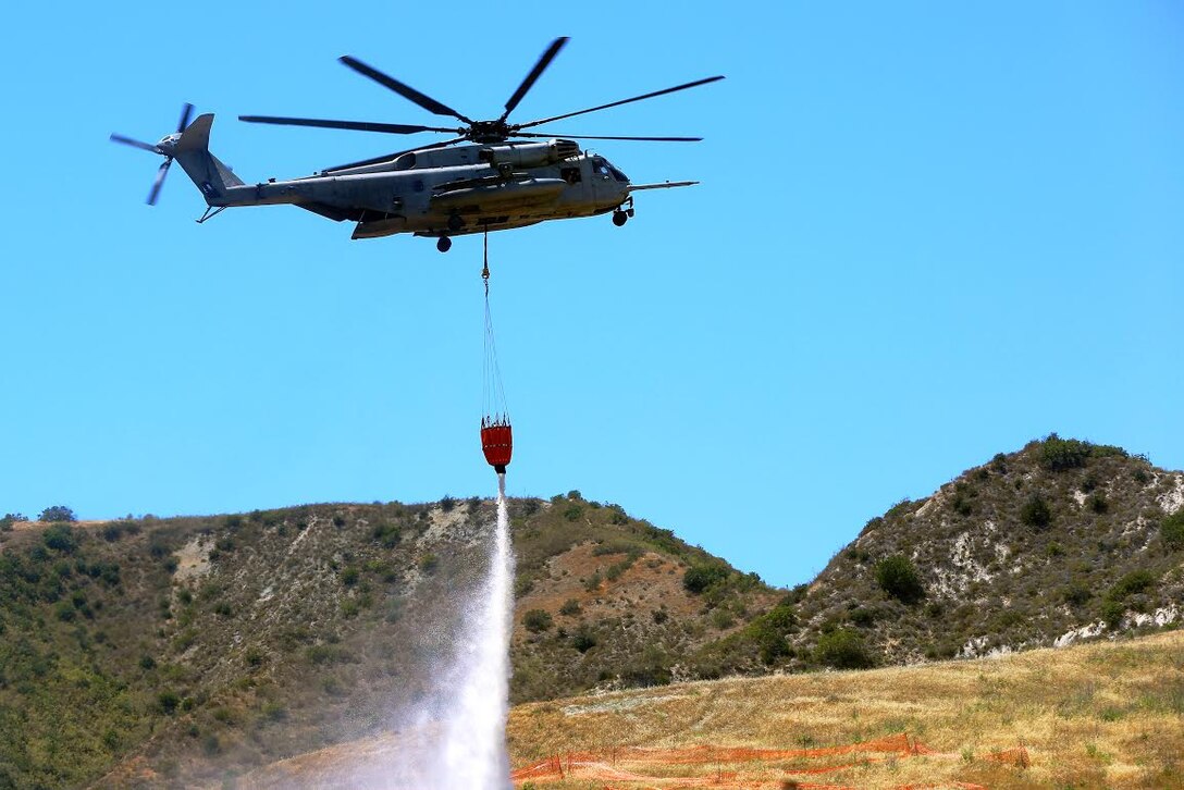 A CH-53E Super Stallion with Marine Heavy Helicopter Squadron 466, 3rd Marine Aircraft Wing, drops water onto a mock fire area during an aerial firefighting exercise here, April 30. Aviation and ground units from Camp Pendleton, 3rd MAW, Navy Region Southwest, the California Department of Forestry and Fire Protection, and the San Diego Sheriff’s Department participated in the annual exercise, which provides ready, trained and certified military and civilian resources to combat wild land fires in the region.