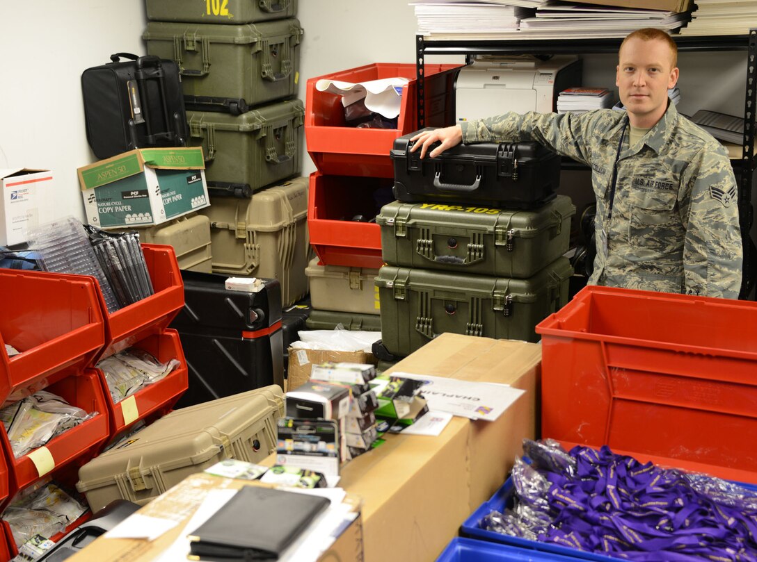 Senior Airman Kyle McCollum, AFRC Yellow Ribbon logistics manager, stands among hundreds of itiems in a storage room at Robins Air Force Base, Ga., that he must inventory and ship to Yellow Ribbon events. (Air Force photo/Master Sgt. Chance Babin)