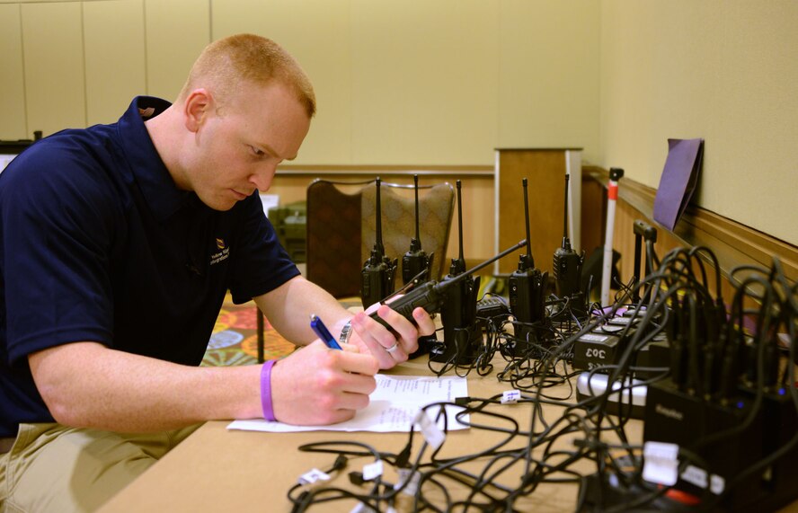 Senior Airman Kyle McCollum, AFRC Yellow Ribbon logistics manager, inventories a hand held radio during a Yellow Ribbon event in Orlando. McCollum is responsible for inventory and shipment of all Yellow Ribbon supplies for each event throughout the year. (Air Force photo/Master Sgt. Chance Babin)