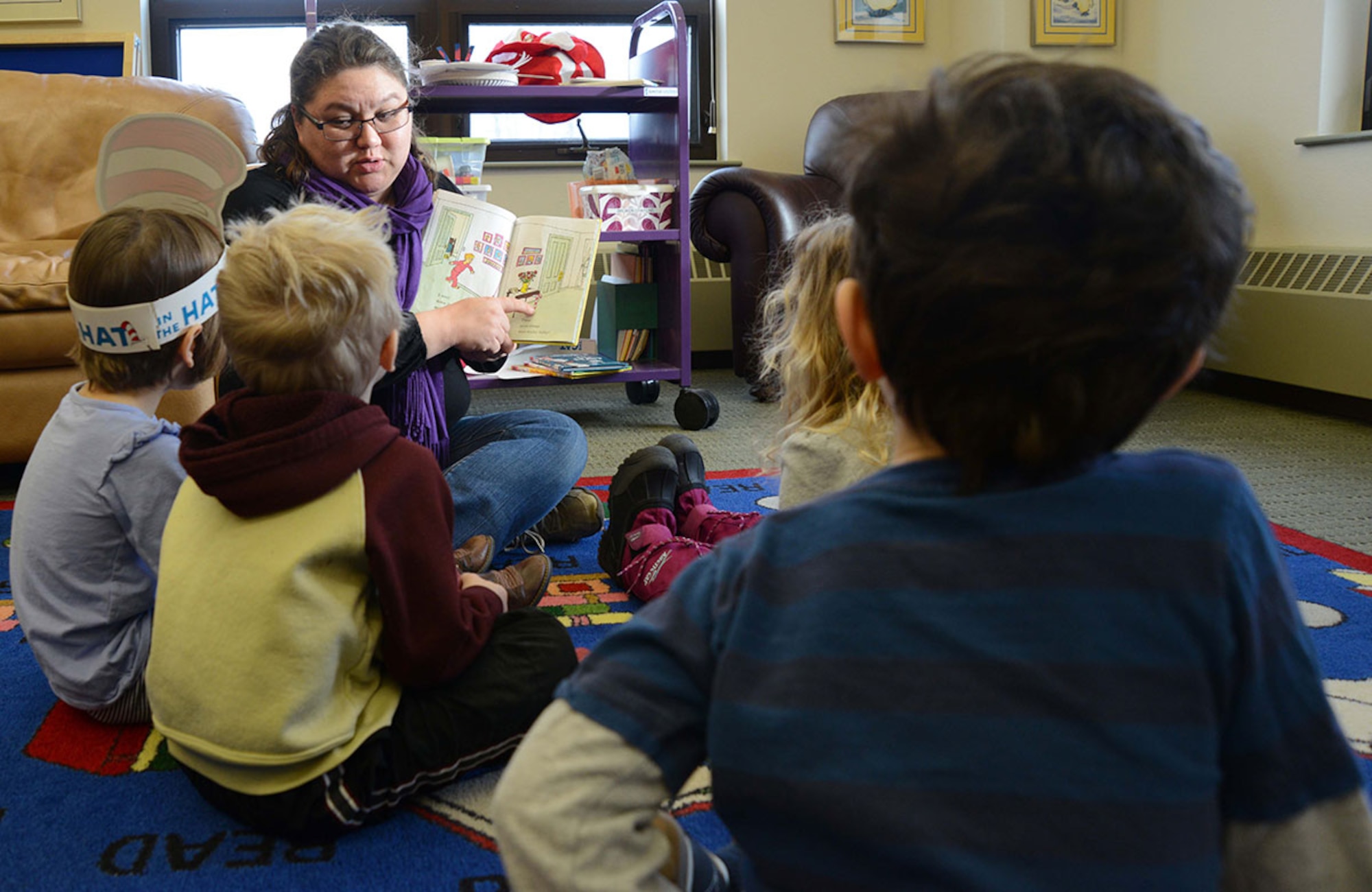 Tesha Mulkey, a 673rd Force Support Squadron library technician, reads to children at the Consolidated Library on March 3, 2015, at Joint Base Elmendorf-Richardson, Alaska. The 673rd FSS earned the Air Force Curtis E. LeMay award for best large installation-level FSS of the year in the Air Force for 2014. (Air Force photo/Airman Christopher R. Morales)
