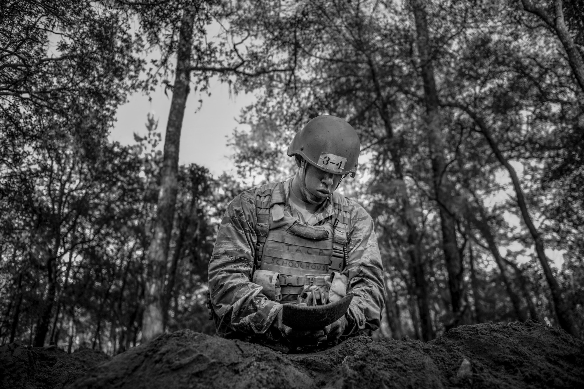 A Tactical Air Control Party candidate from Falcon 98 digs a sleeping hole during a field training exercise at Eglin Range, Fla., March 24, 2015. TAC-P candidates from Falcon 98 are the last class to graduate from Hurlburt Field, Fla., before the schoolhouse moves to Lackland Air Force Base, Texas. (U.S.  Air Force photo/Senior Airman Christopher Callaway)