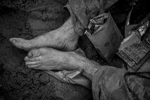 A Tactical Air Control Party candidate from Falcon 98 eats an MRE during a field training exercise at Eglin Range, Fla., March 24, 2015. TAC-P candidates from Falcon 98 are the last class to graduate from Hurlburt Field, Fla., before the schoolhouse moves to Lackland Air Force Base, Texas. (U.S.  Air Force photo/Senior Airman Christopher Callaway)