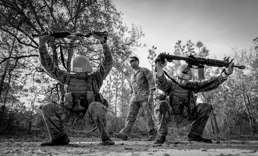 Tactical Air Control Party candidates from Falcon 98 perform squats during a field training exercise at Eglin Range, Fla., March 24, 2015. TAC-P candidates from Falcon 98 are the last class to graduate from Hurlburt Field, Fla., before the schoolhouse moves to Lackland Air Force Base, Texas. (U.S.  Air Force photo/Senior Airman Christopher Callaway)
