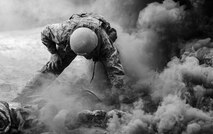 A Tactical Air Control Party candidate from Falcon 98 ensures his gear is in tact after a training smoke grenade detonated near his position during training at Eglin Range, Fla., March 24, 2015. TAC-P candidates from Falcon 98 are the last class to graduate from Hurlburt Field, Fla., before the schoolhouse moves to Lackland Air Force Base, Texas. (U.S.  Air Force photo/Senior Airman Christopher Callaway)