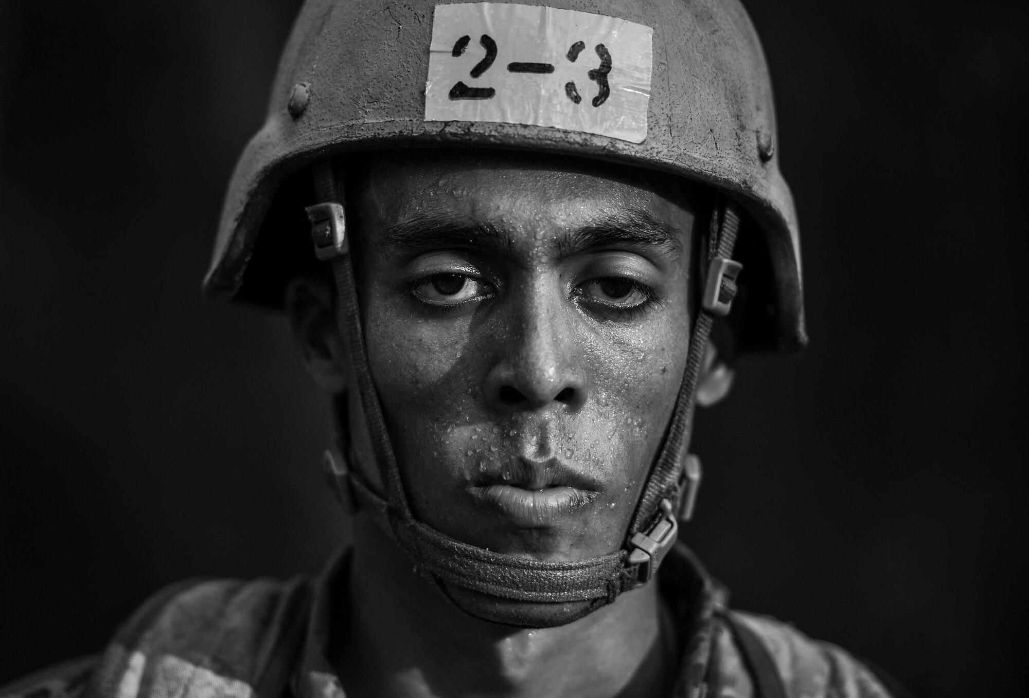 A Tactical Air Control Party candidate from Falcon 98 stands at attention during a field training exercise at Eglin Range, Fla., March 24, 2015. TAC-P candidates from Falcon 98 are the last class to graduate from Hurlburt Field, Fla., before the schoolhouse moves to Lackland Air Force Base, Texas. (U.S.  Air Force photo/Senior Airman Christopher Callaway)