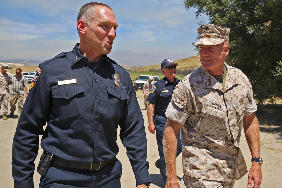 Thom Porter, left, assistant region chief with the California Department of Forestry and Fire Protection, speaks to Brig. Gen. Edward Banta, Marine Corps Base Camp Pendleton, Marine Corps Installations – West, during an aerial firefighting exercise at Las Pulgas Lake here, April 30. The exercise was the eighth iteration of its kind and showcased the employment of trained and certified military and civilian personnel using aircraft to combat wildland fires in the region. (Photo by Cpl. Shaltiel Dominguez)