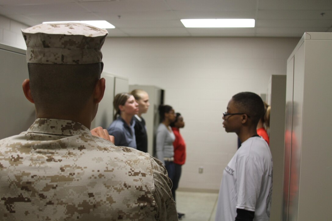 U.S. Marine Corps Staff Sgt. Keun Chung, a sergeant instructor at Officer Candidate School, Marine Corps Base Quantico, Virginia, instructs female candidates on how to properly stand on line during a mini Officer Candidates School training event, at Camp Sherman Joint Training Center in Chillicothe, Ohio, April 25, 2015. Candidates endured many physical and mental challenges during their mini OCS such as limited sleep and long days filled with land navigation, combat maneuvers and leadership development. (U.S. Marine Corps photo by Cpl. Kyle Welshans/Released)