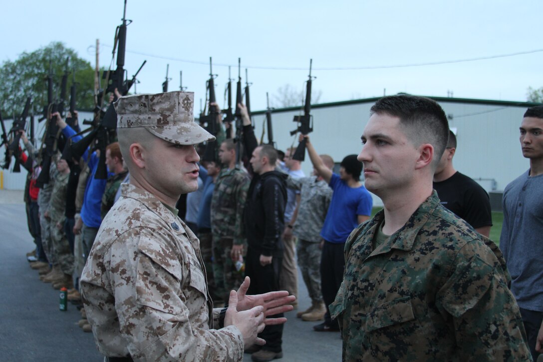 U.S. Marine Corps Staff Sgt. Paris Skidmore, a sergeant instructor at Officer Candidates School at Marine Corps Base Quantico, Virginia, instructs his squad on how to get accountability while in a formation, at Camp Sherman Joint Training Center in Chillicothe, Ohio, April 25, 2015. Candidates endured many physical and mental challenges during their mini OCS such as limited sleep and long days filled with land navigation, combat maneuvers and leadership development. (U.S. Marine Corps photo by Cpl. Kyle Welshans/Released)