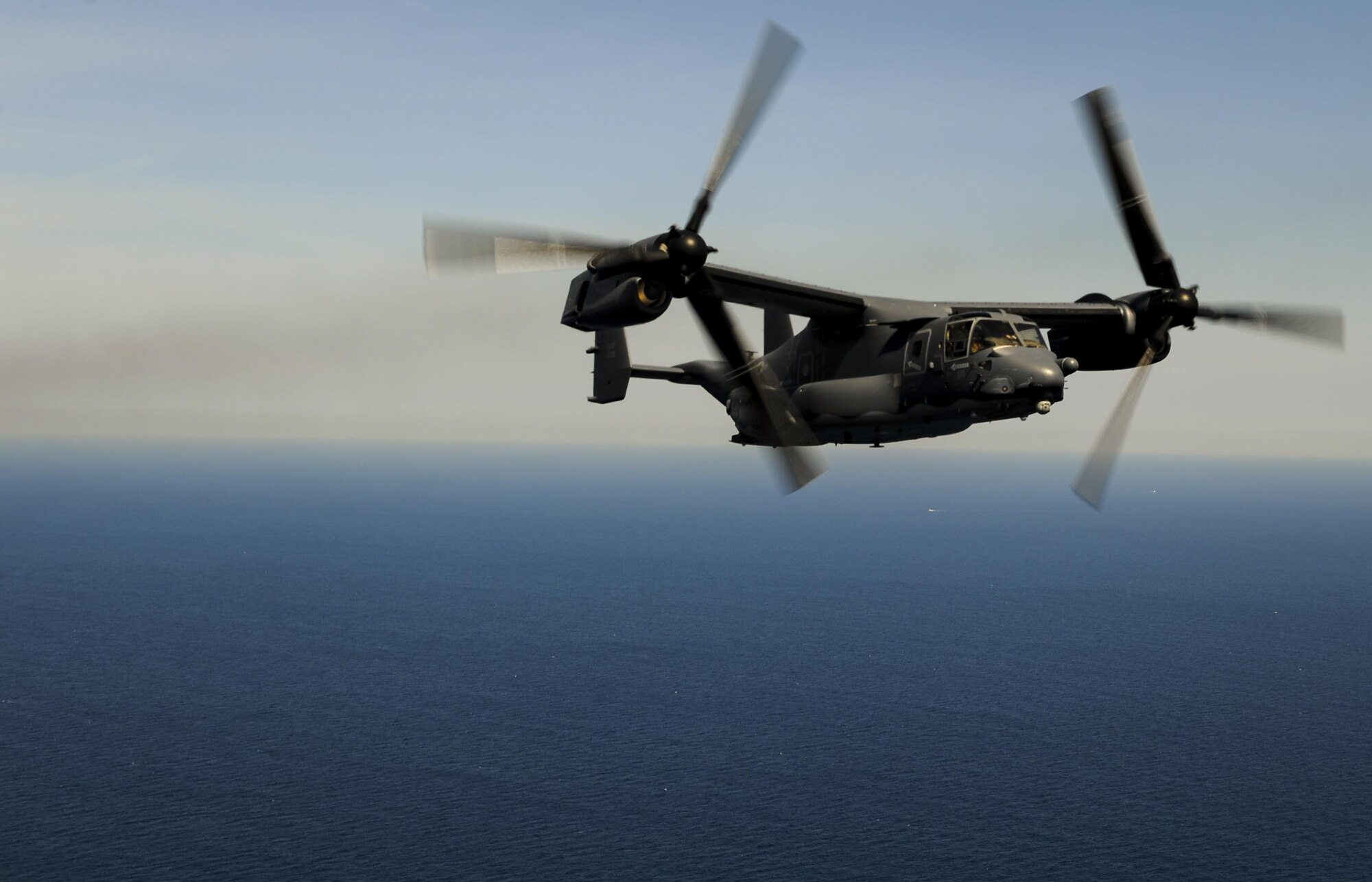 A CV-22 Osprey flies in formation with a MC-130H Combat Talon II over Fort Walton Beach, Fla., April 24, 2015. Two Ospreys trailed a MC-130 Combat Talon II during a flyover of the Hurlburt Field, Fla., Airpark during an annual Operation Eagle Claw ceremony.  (U.S. Air Force photo/Senior Airman Christopher Callaway)